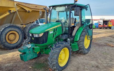 a tractor that is parked in the dirt