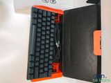 a black and orange keyboard in a black box