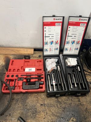 two sets of tools are sitting on the floor next to each other