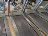 row of treads in a gym room with mirrors on the wall