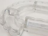 two clear glass ashtrays sitting on a white table