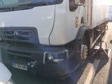 a white truck that is parked next to a trailer