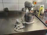 a mixer on the counter in the kitchen with a whisk attachment