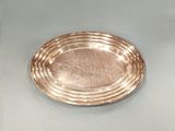a silver plate sitting on top of a glass table
