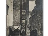 an old photo of a man on a lift in the street