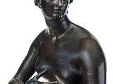 statue of a woman holding her hands on her chest
