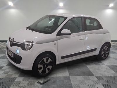 a picture of a small white car parked on a checkered floor