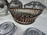 a silver bowl with a lid sitting on a table