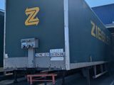 two semi trucks that are parked in a parking lot