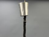 a close up of a metal object on a black stand