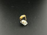 a close up of a gold ring on a black surface