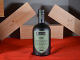 a bottle of alcohol sitting on a red cloth