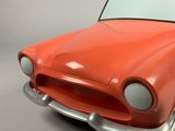 an orange toy car that is sitting on a table