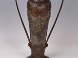 a vase that is sitting on a white surface
