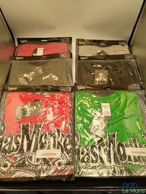 many t - shirts that are sitting on a shelf