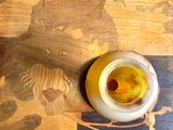 a jar of honey sitting on a wooden table