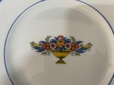 a plate with a flower arrangement on it on a table