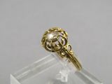 a close up of a gold ring with a flower design on it