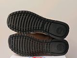 the soles of a pair of black shoes are on a box
