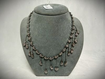 silver necklace with crystal drops on a mannequin display