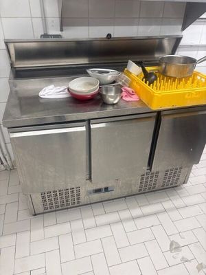 a stainless steel kitchen with a sink and a dishwasher on the counter