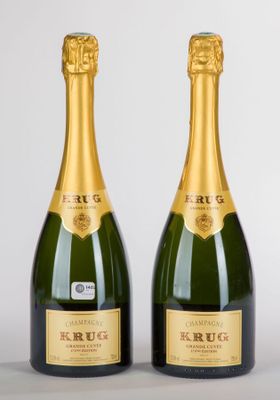 deux bouteilles de champagne posées l'une à côté de l'autre sur une table