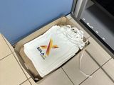 a box with a t - shirt inside of it on the floor