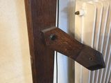 a close up of a wooden door handle on a radiator