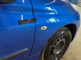a close up of a blue car with a sticker on it