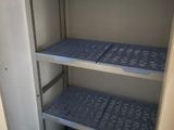 two shelves in the closet of a small room