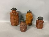 three brown vases with lids are sitting next to each other
