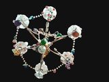 a chandelier made of glass beads on a black background