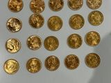 a lot of gold coins sitting on a white surface