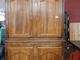 a large wooden cabinet in the middle of a room