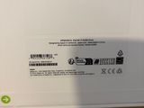 the back of a white box with a black and green label on it