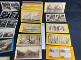 a lot of old black and white photos on the table