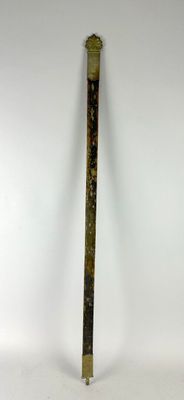 a metal pole with a wooden handle on a white surface