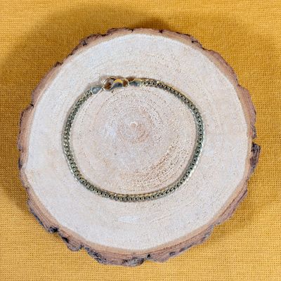 a picture of a wooden slice with a ring on it