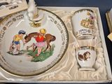 a tray with silverware and a plate with a picture of children on it