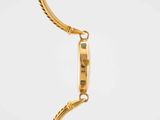 a close up of a gold watch with a chain around it