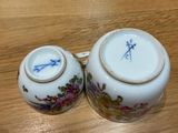 two cups that are sitting on a wooden table