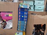 a pile of shoes and boxes on a pallet in a garage