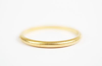 a close up of a gold ring on a white surface