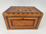 a wooden box with a star design on the lid