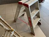 a ladder that is sitting on the floor in a room