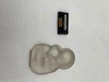 a small statue of a person and a small battery