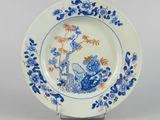 a blue and white plate with a blue and orange design on it