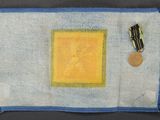 an image of a piece of cloth with a medal on top of it