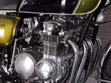 a black and green motorcycle parked in a garage