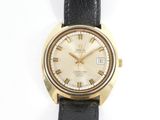 an image of a gold watch with roman numerals on a black strap